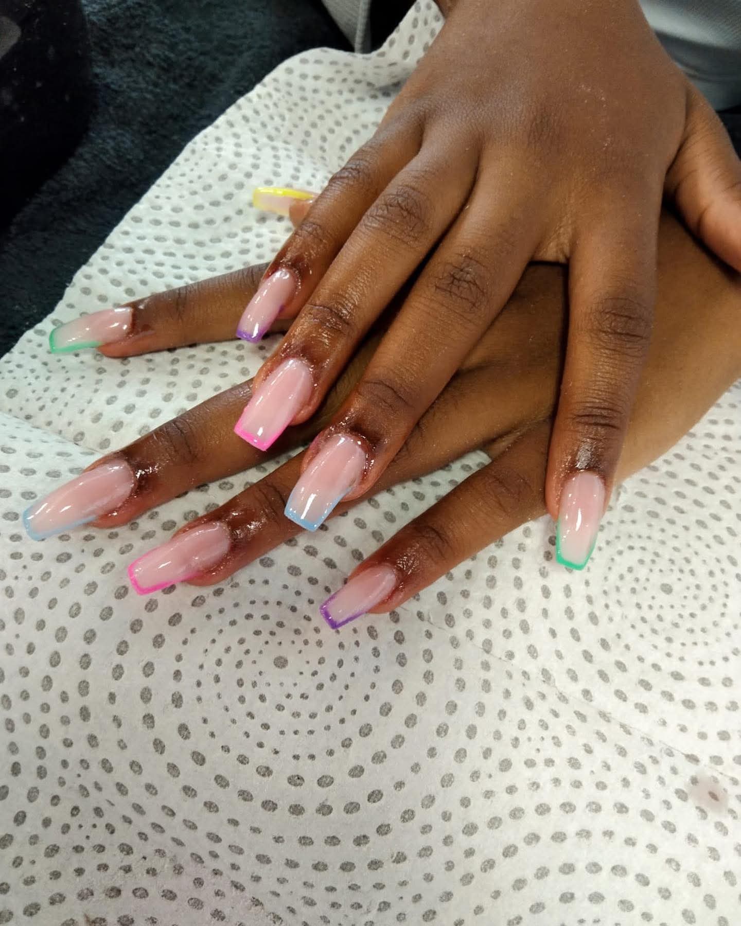 Nude coffin nails with pastel neon French tips