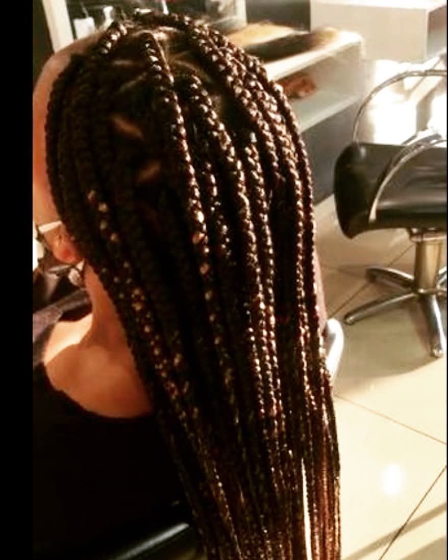 Fresh medium-length knotless box braids in auburn tones